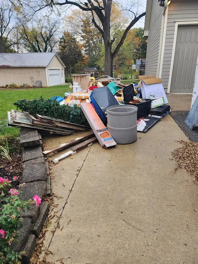 Dumpster being loaded with debris for Roofing Dumpster Rental in Carson